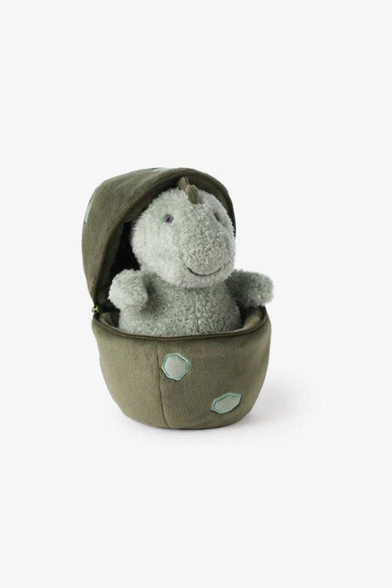 Plush dinosaur sitting inside sage-green egg shell.