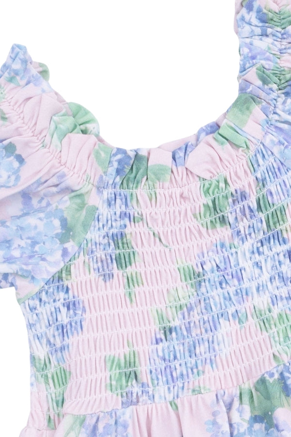 Smocked bodice dress with pastel floral print and elastic ruffles at neckline