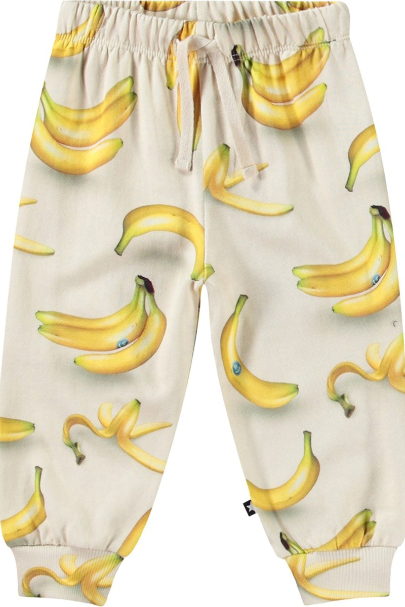 Cream jogger pants with allover yellow banana print and elastic cuffs