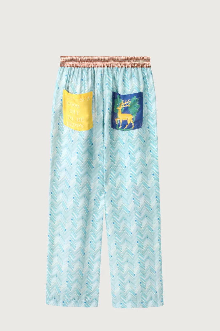 Light blue wide-leg pants with elastic waist and yellow/blue side patch pockets