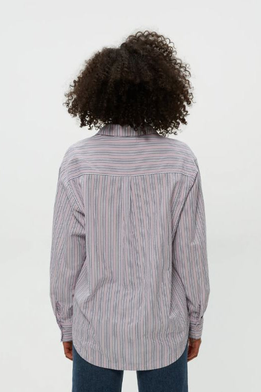 Back view of oversized button-down shirt in lavender with blue vertical pinstripes