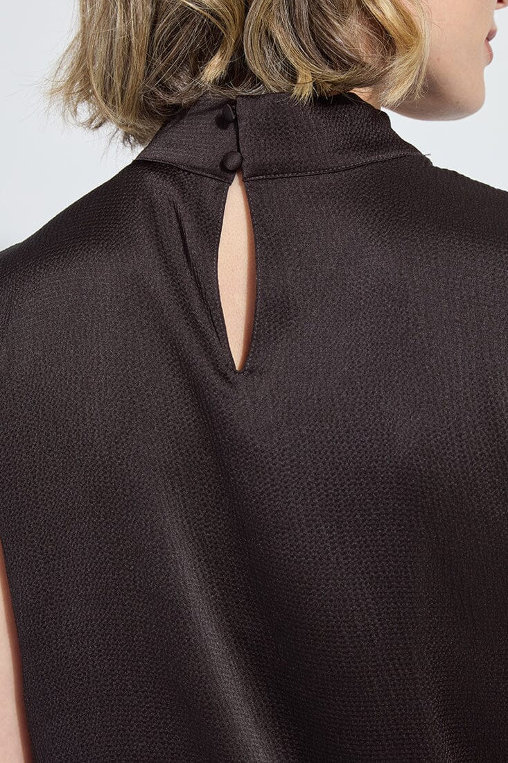 Close-up back of high-neck sleeveless blouse with keyhole and button, dark brown