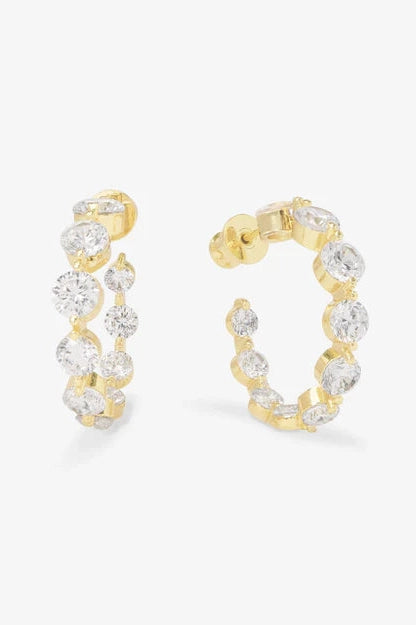 Gold hoop earrings with bright white crystal stones in a circle
