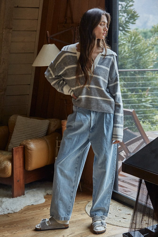 Striped pullover sweater in slate blue with off-white V-neck and ribbed cuffs, long sleeves