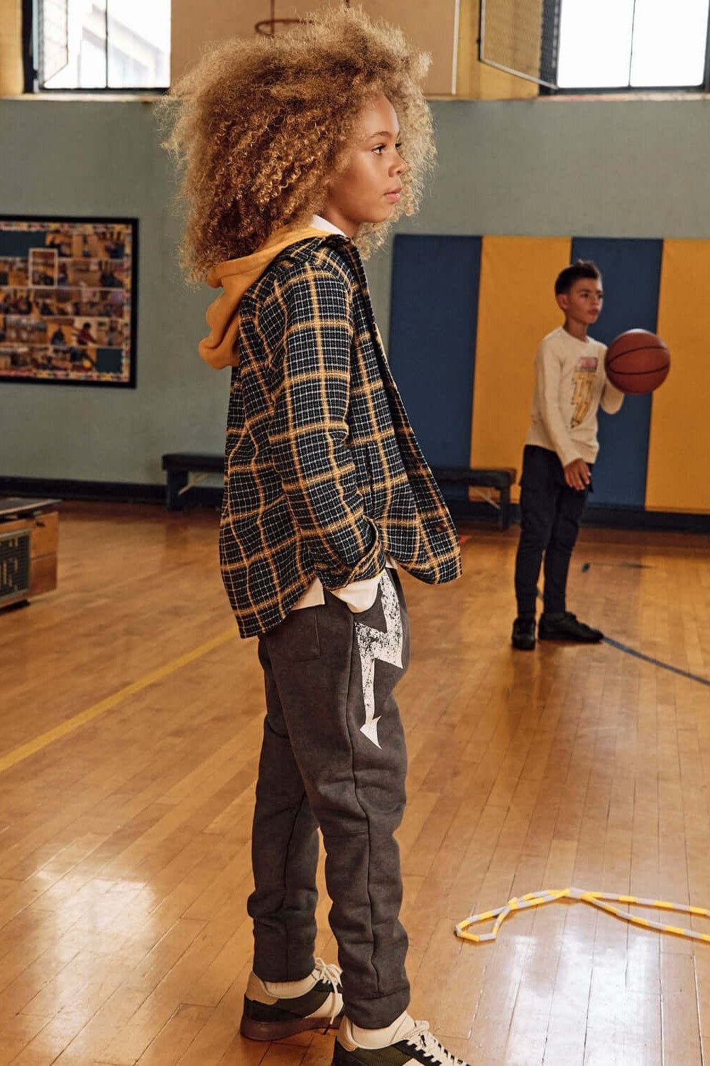 Kids sweatpants in dark gray with side gray panel and white graphic, cuffed legs