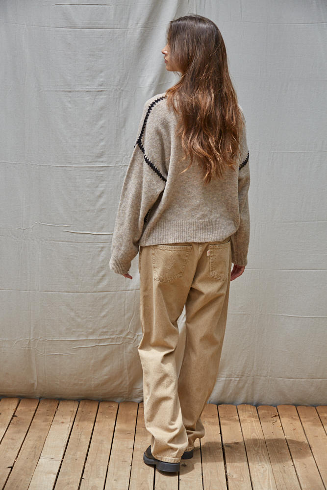 Mocha knit sweater back view with contrast whipstitch trim on shoulder and sleeves