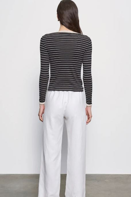 Back view of striped long-sleeve tee with crew neck, dark base and light stripes