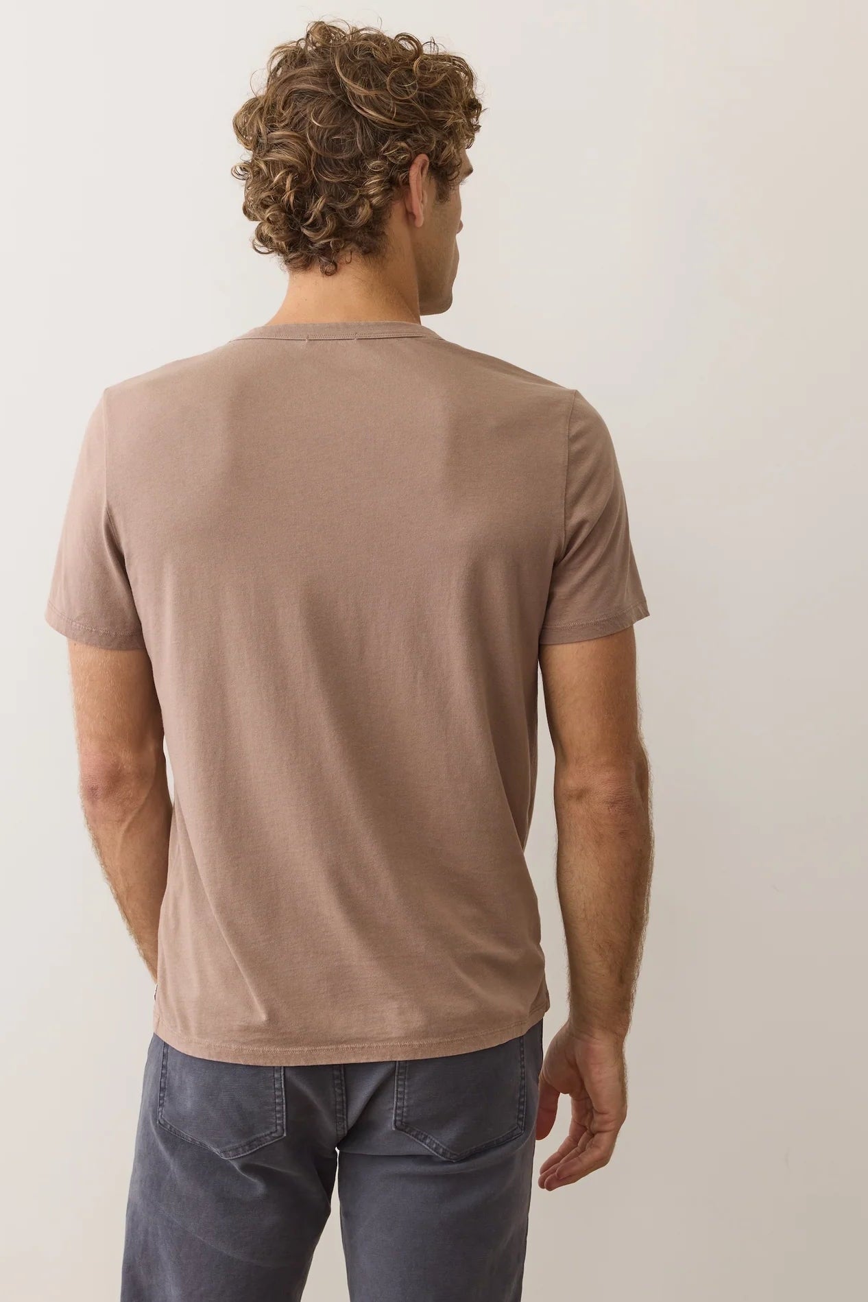 Brown crew neck T-shirt with short sleeves and small side logo patch