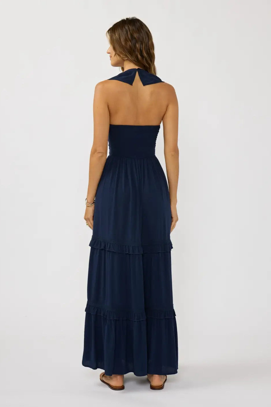 Navy v-neck tiered maxi dress with lace-trimmed tiers and open-back V strap