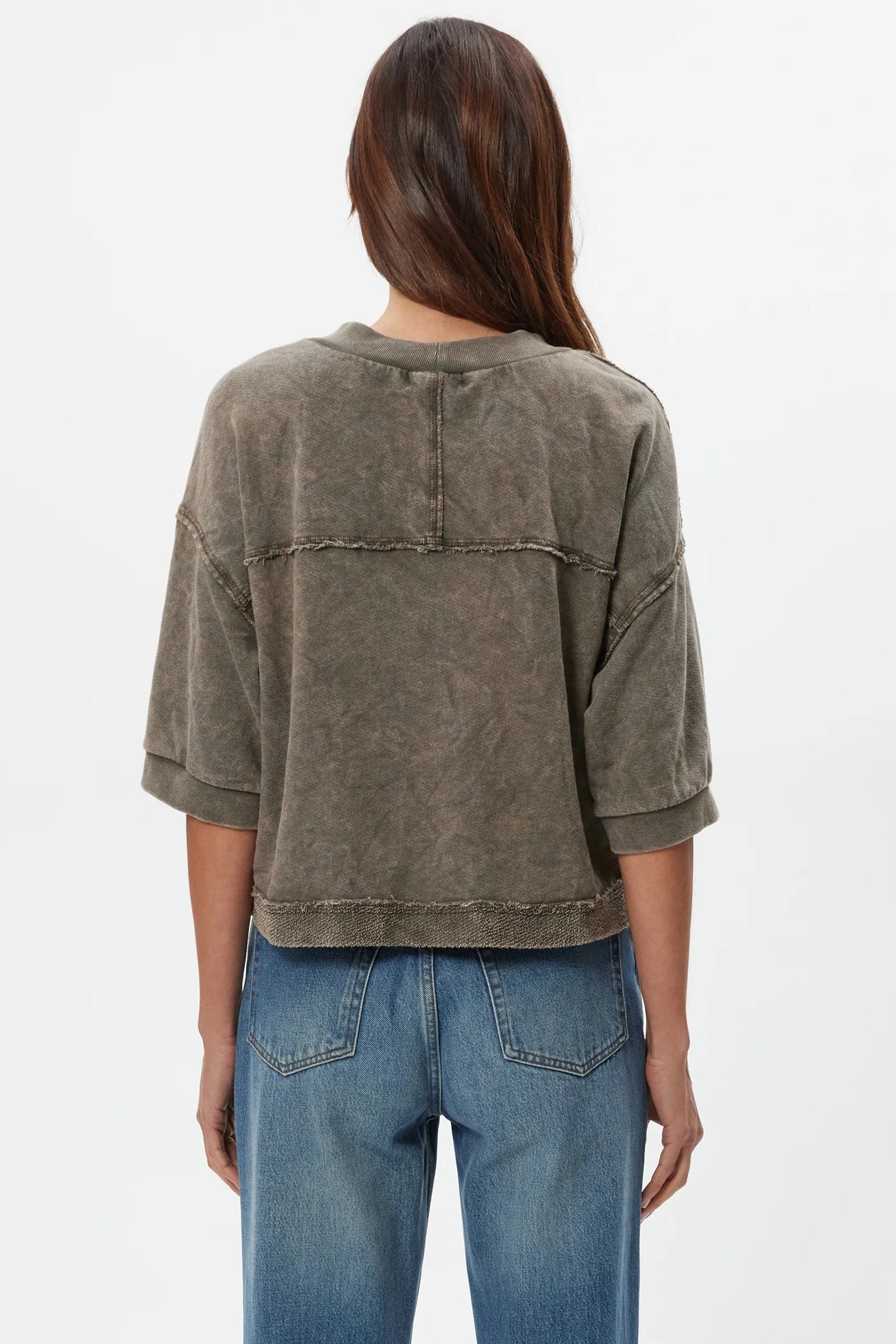 Back view of dark caper wide-sleeve cardigan with yoke seam and stitched hem