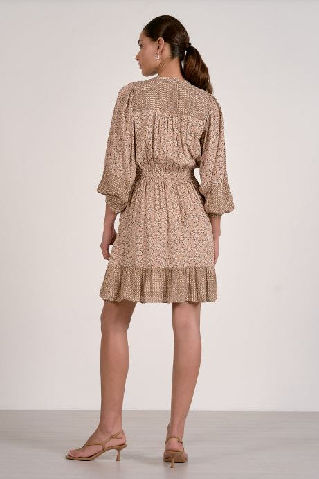 Natural long-sleeve tiered mini dress with gathered waist and textured fabric, back view