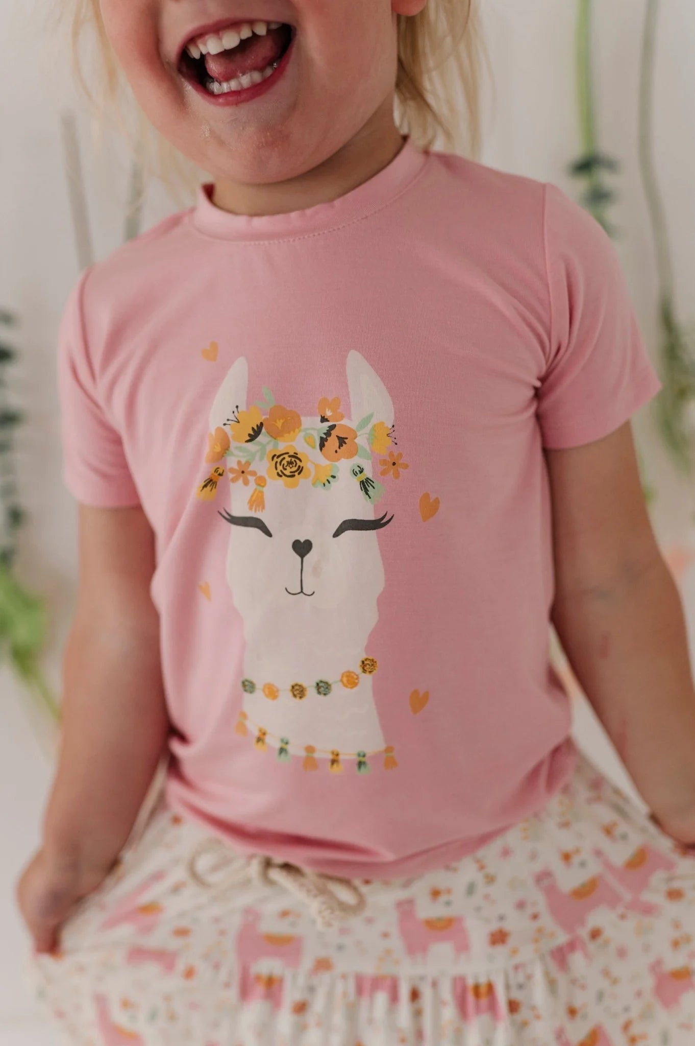 Pink llama graphic T-shirt with colorful flowers and hearts