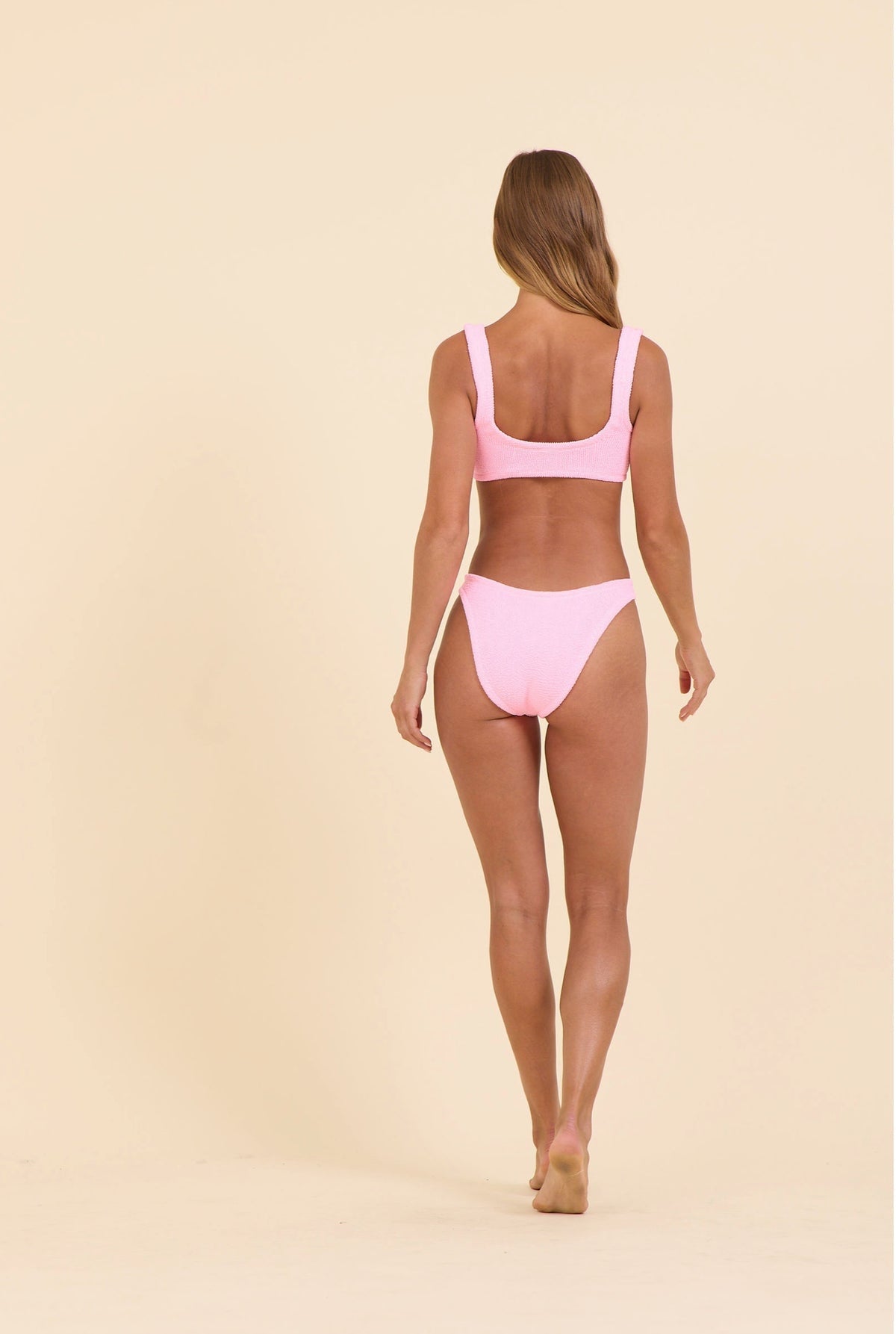 High-waist bikini bottoms in pink, open back with ruched krinkle texture