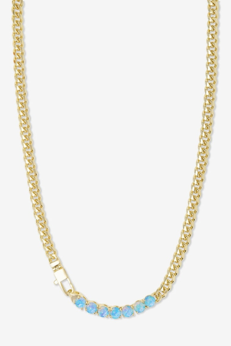 Gold chain necklace with blue stones on a white background