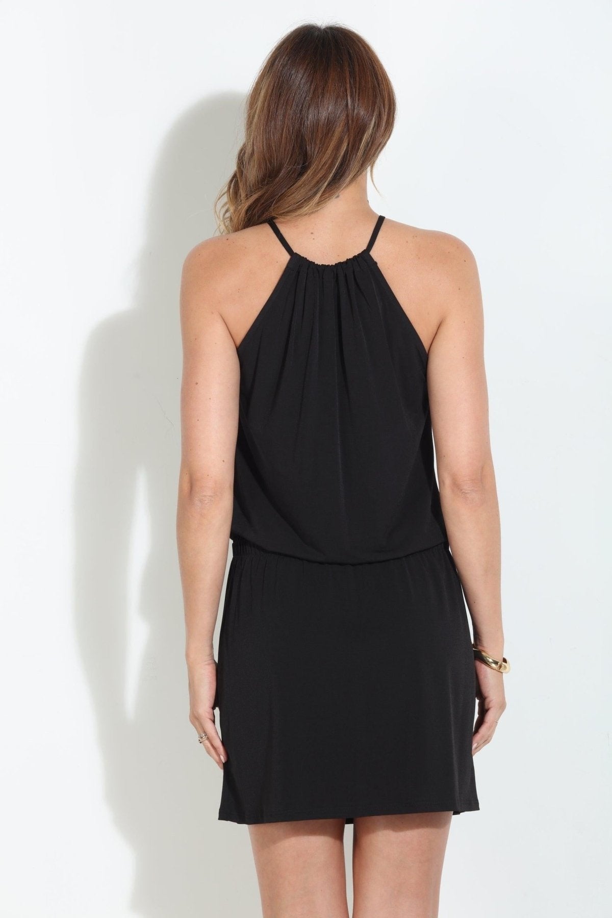 Black sleeveless halter dress, open back, gathered waist, above-knee length