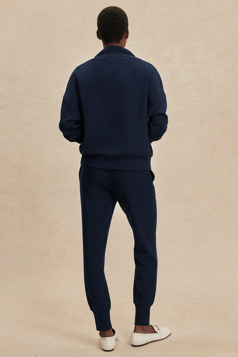 Navy slim cuff pants with ribbed cuffs, back view.
