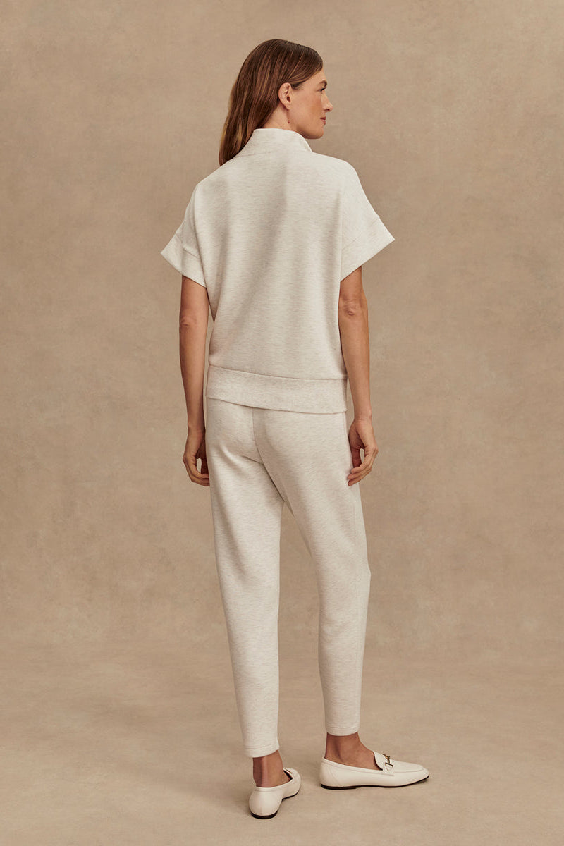Ivory marl slim pants, back view with tapered legs and cuffed hem