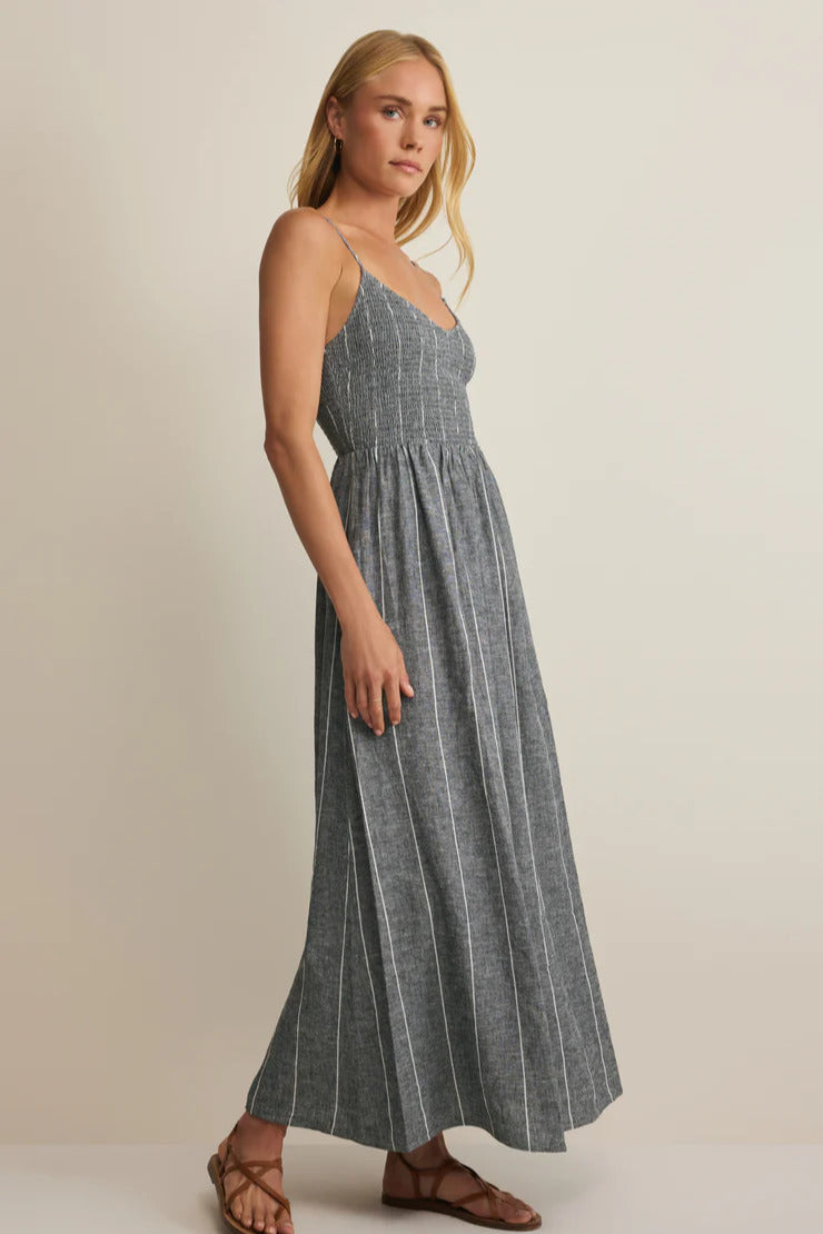 Side view of dark gray striped maxi dress with V-neck straps and gathered waist