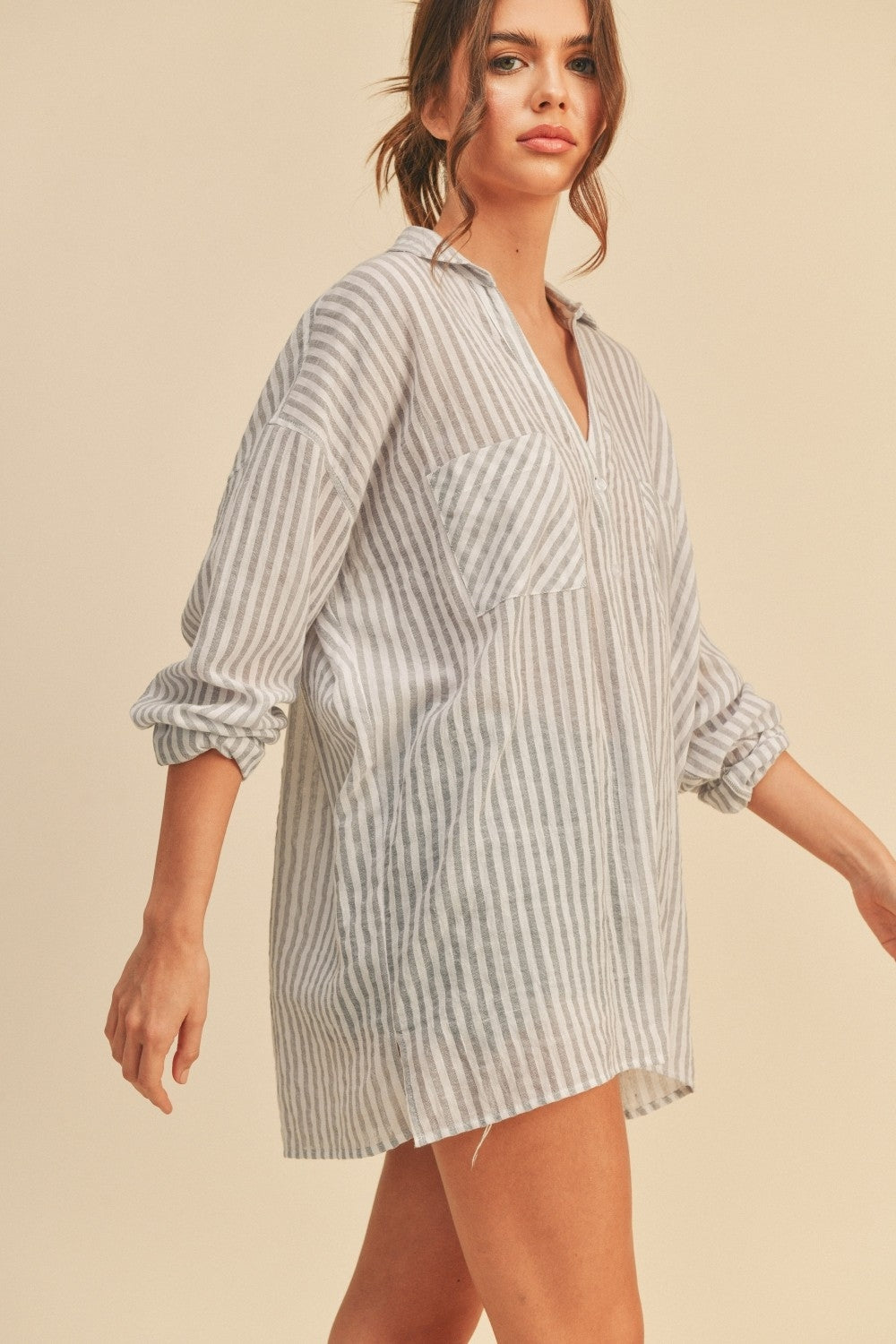 Grey striped button-down shirt with chest pocket, collar, button front, and cuffed sleeves
