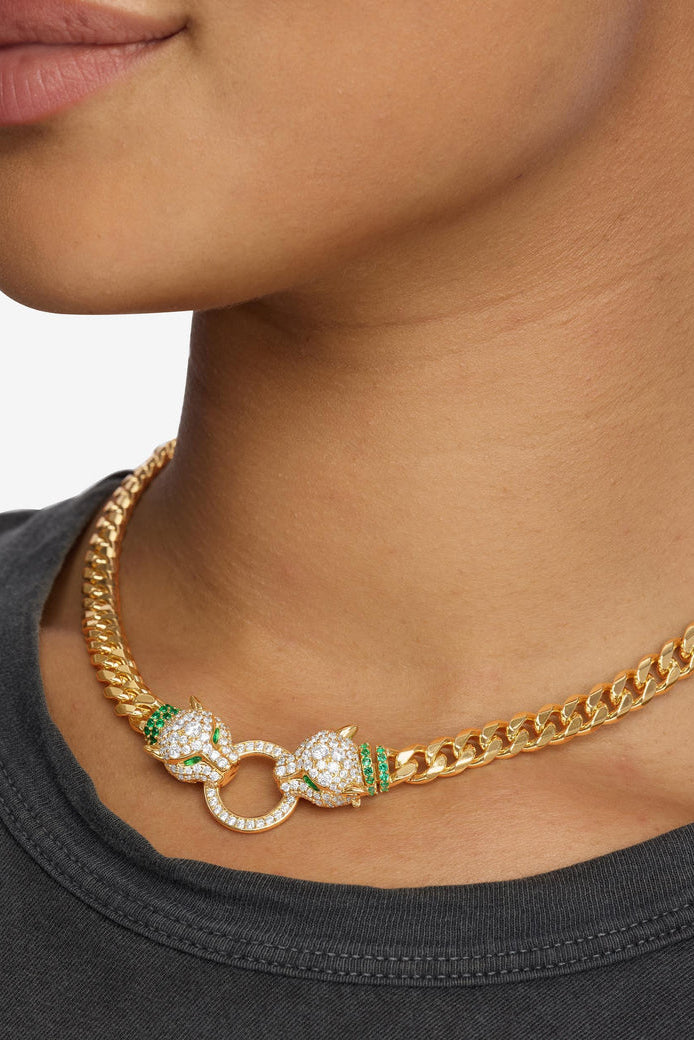 Gold Cuban link necklace with sparkling oval links, green accents, and ring clasp