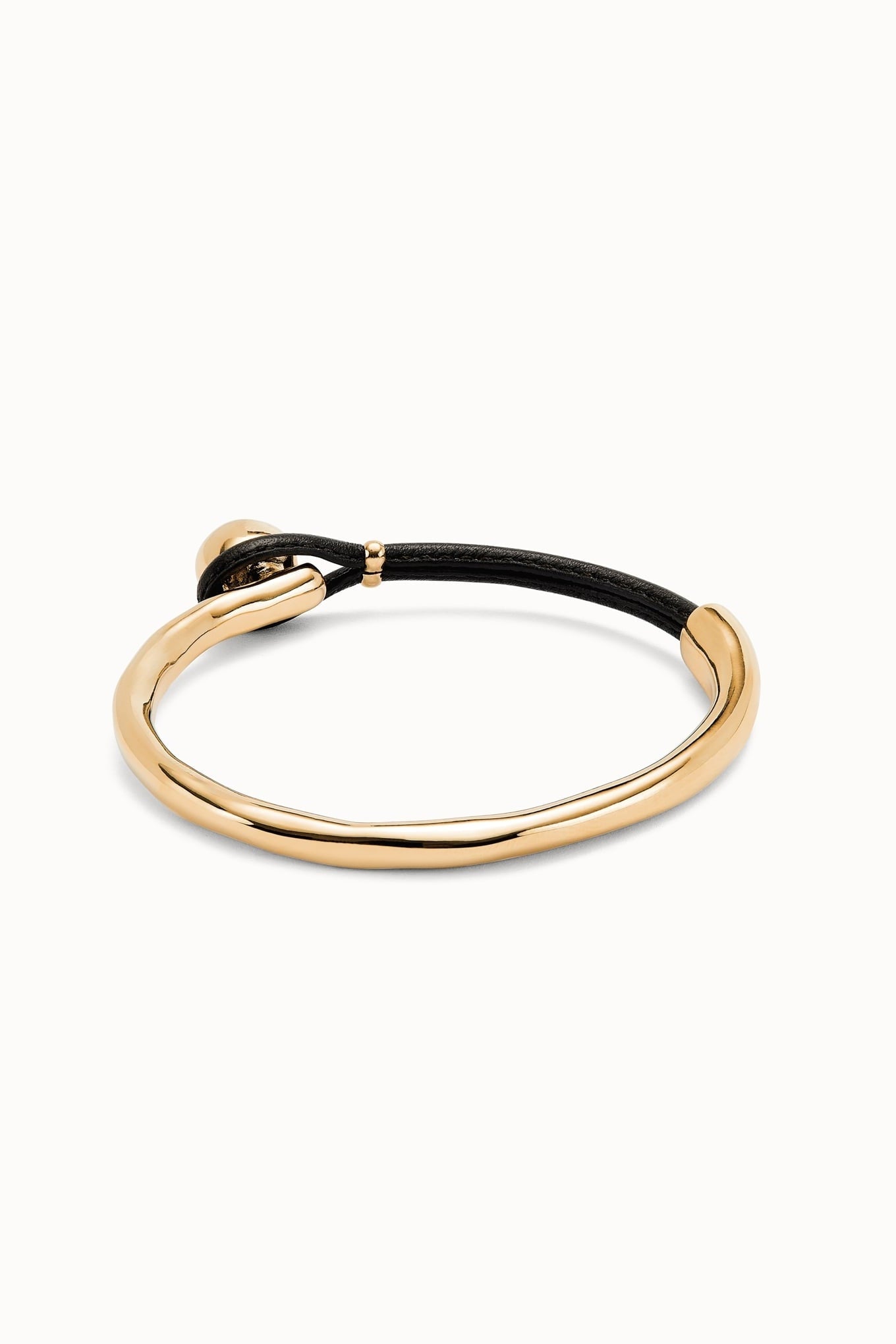 Gold-tone cuff bracelet with black cord wrap and small gold accents