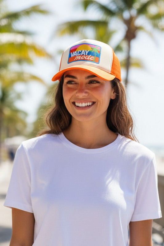 Orange trucker hat with multicolor "VACAY MODE" front patch
