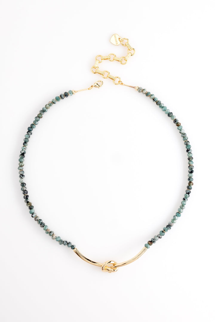 Beaded necklace with dark green and gray beads, gold-toned clasp and knot detail