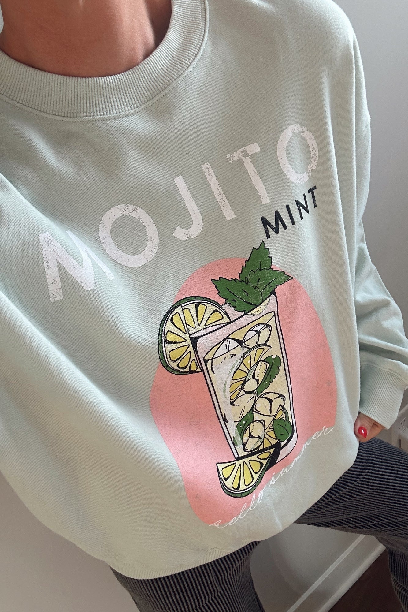 Light green sweatshirt with 'MOJITO MINT' graphic design on a plain background