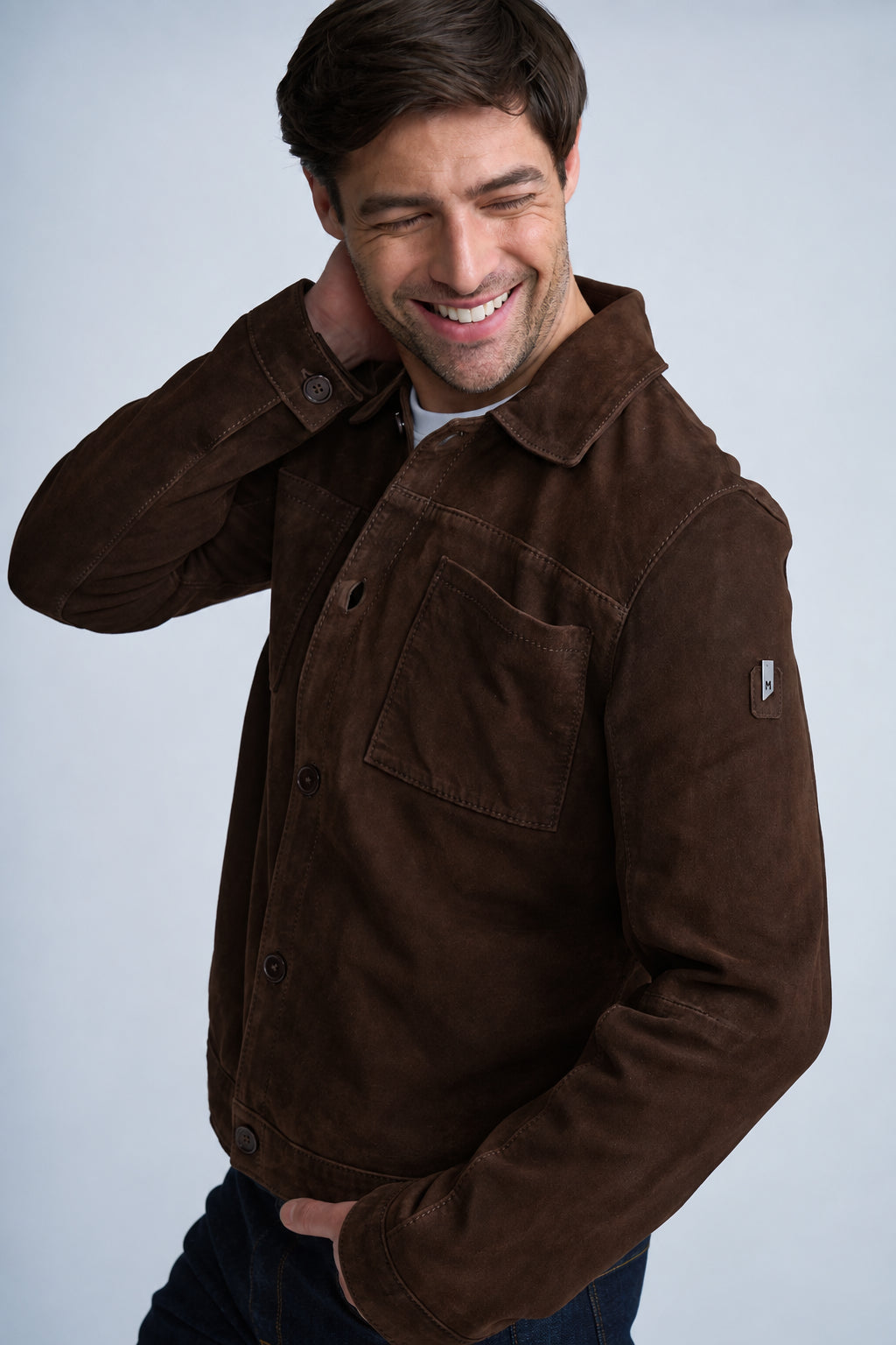 Man wearing jeans and a dark chocolate yukon suede shacket