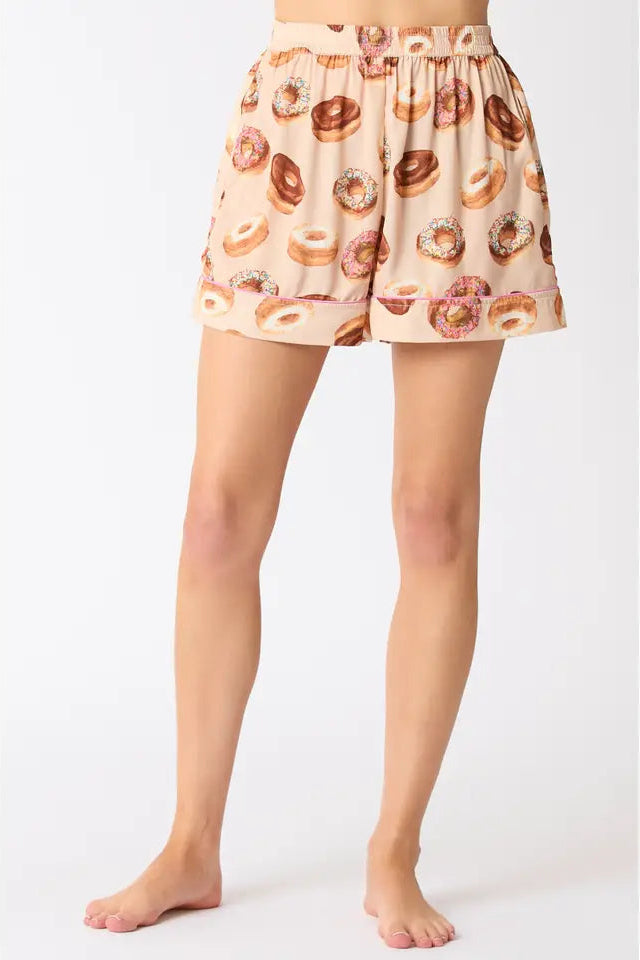 Woman wearing beige satin donut pajama shorts