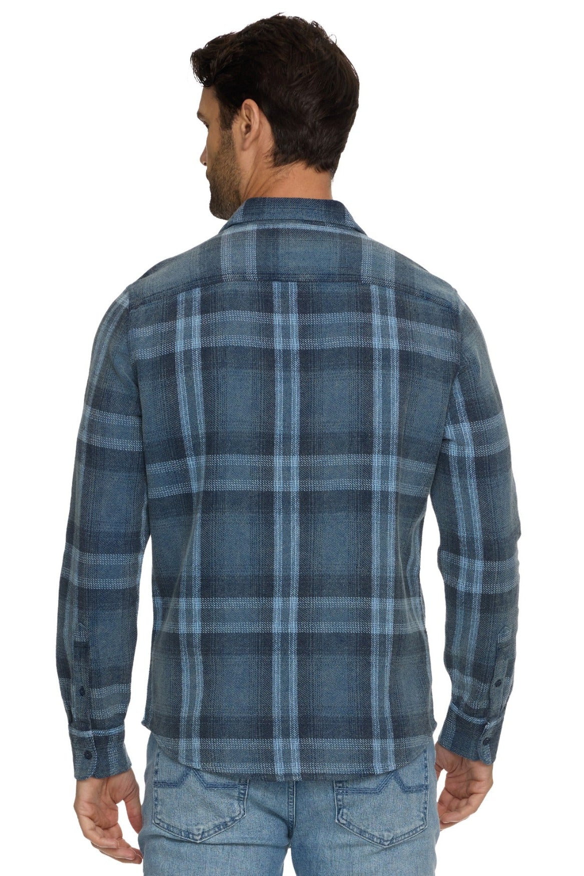 A man viewed from the back wearing a Brundidge blue and gray plaid long-sleeve button-up shirt and light blue jeans against a white background.