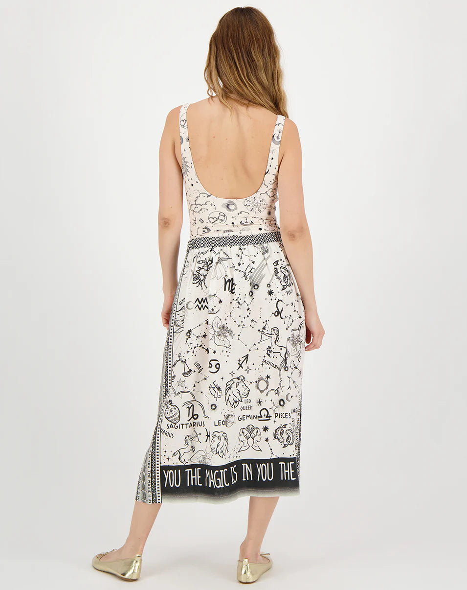 beige midi skirt with black border and zodiac print on model back view