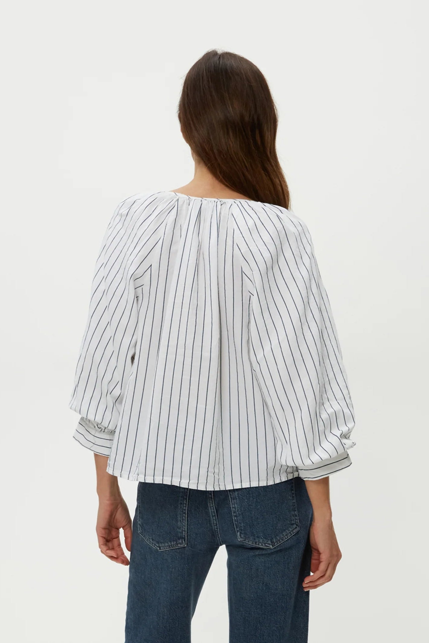 Cleo notch neck top, back view with pleated yoke and full-length striped sleeves