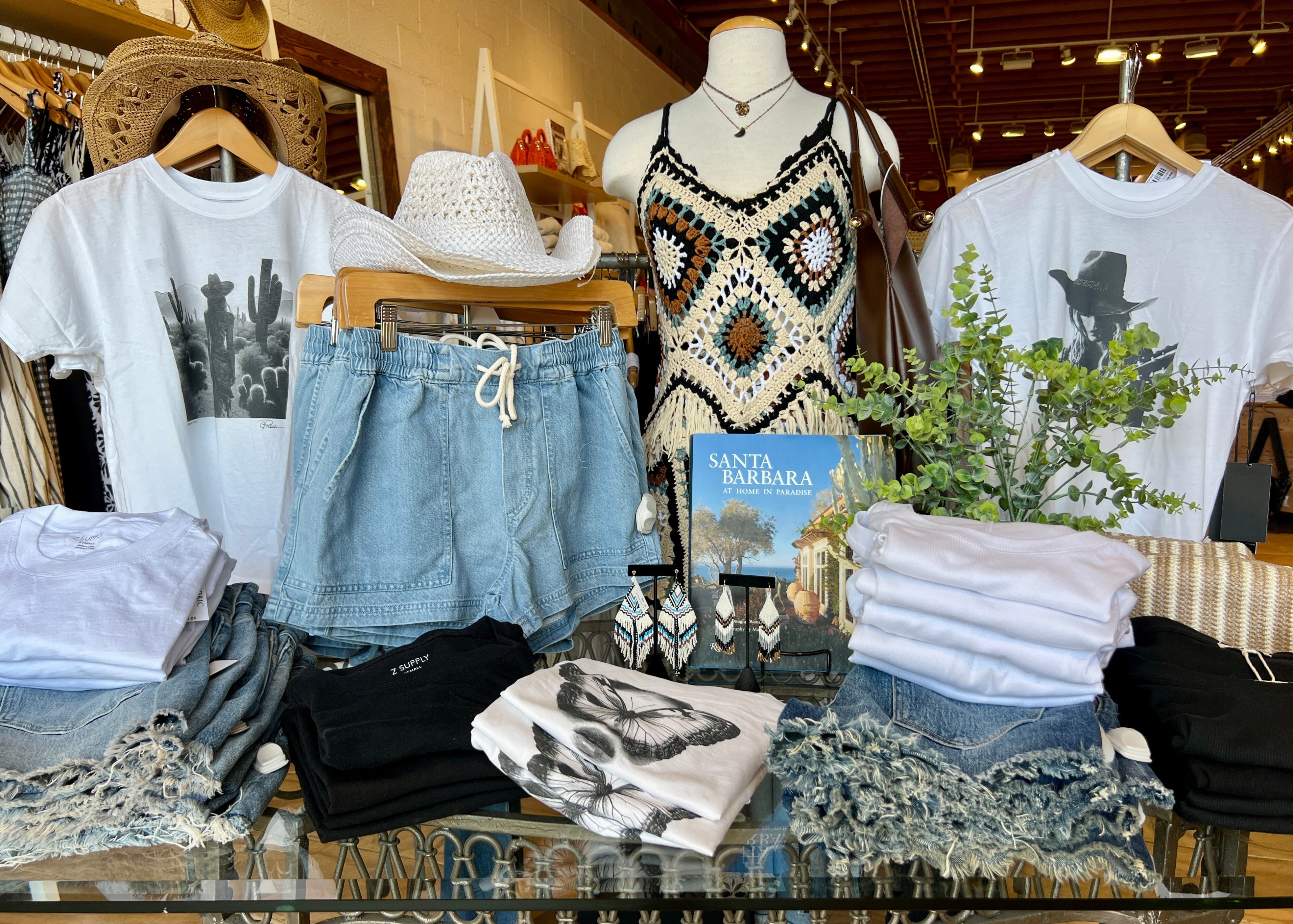 A merchandise table with women's clothing and accessories