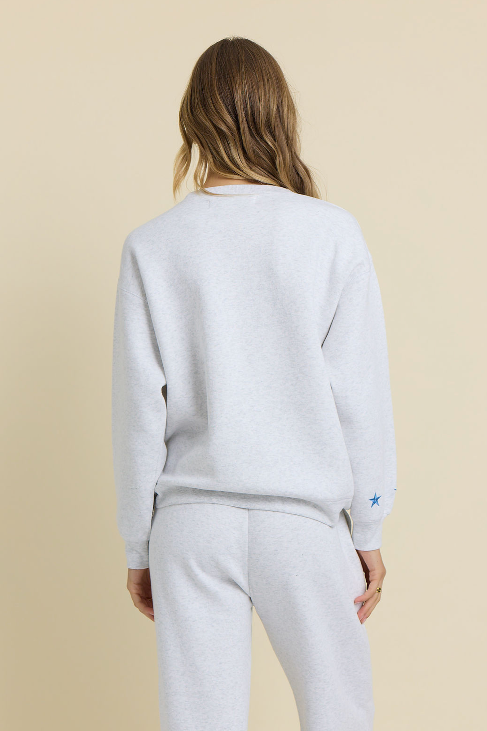 Ash grey embroidered crewneck sweatshirt and sweatpants, back view with star logo