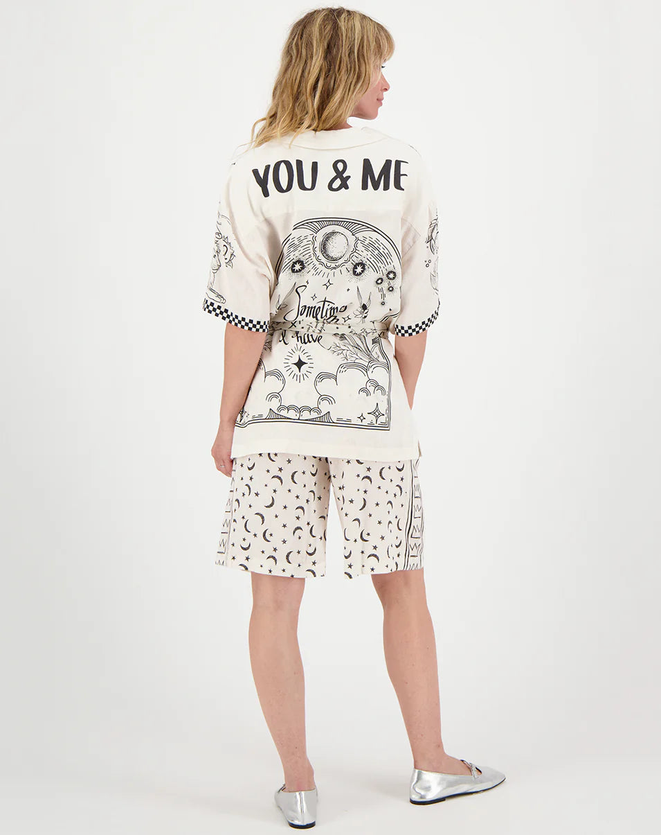 Back view: belted zodiac tunic in white with 'YOU & ME' graphic and matching shorts