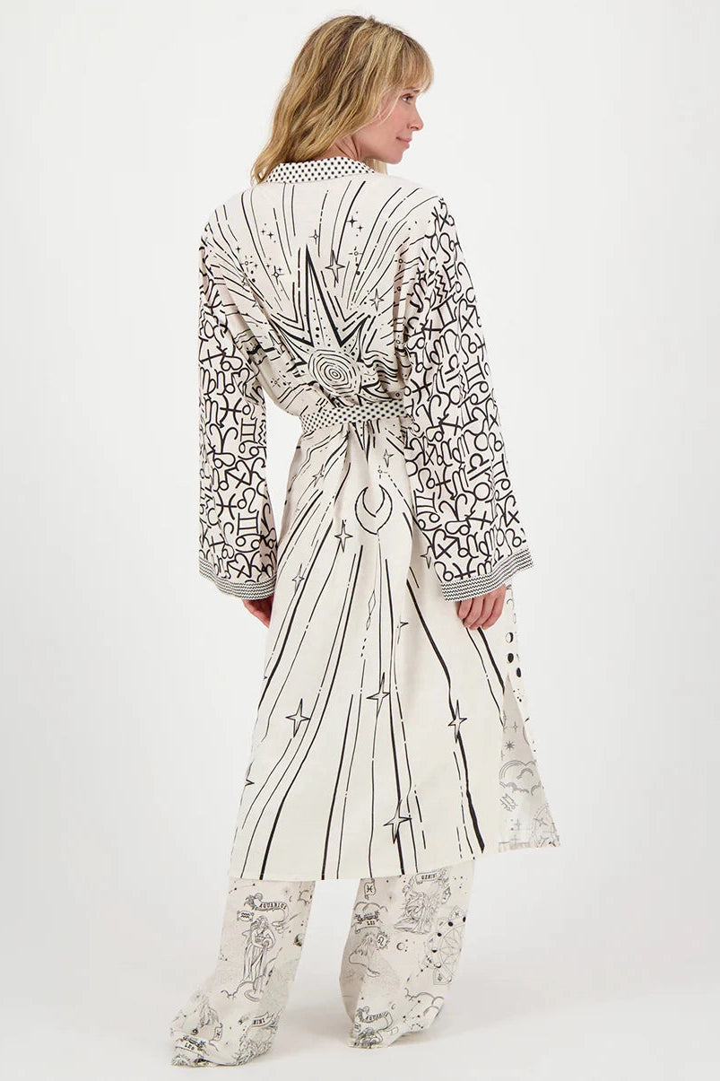 Printed kimono dress, back view, long sleeves and tied waist belt, light doodle pattern