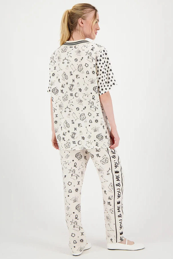 Back view zodiac print pants with elastic waistband and vertical text detail on legs