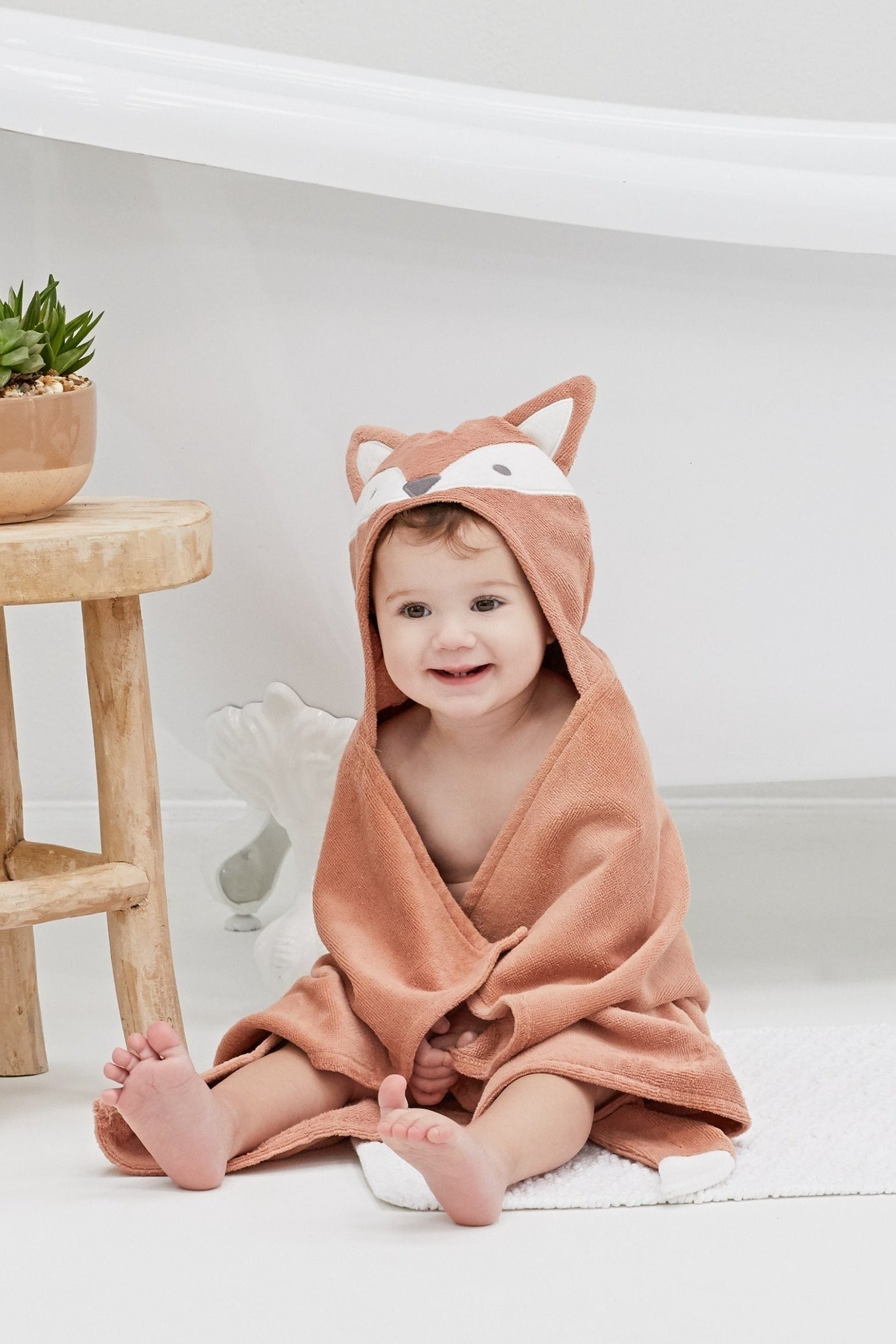 Hooded bath wrap with fox face hood, orange terry, worn by child