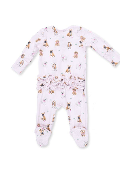Back view of a baby long-sleeve footed sleeper in light pink, featuring an all-over print of small brown and black 'bestie dogs' with a ruffled waistband, shown on a plain white background.