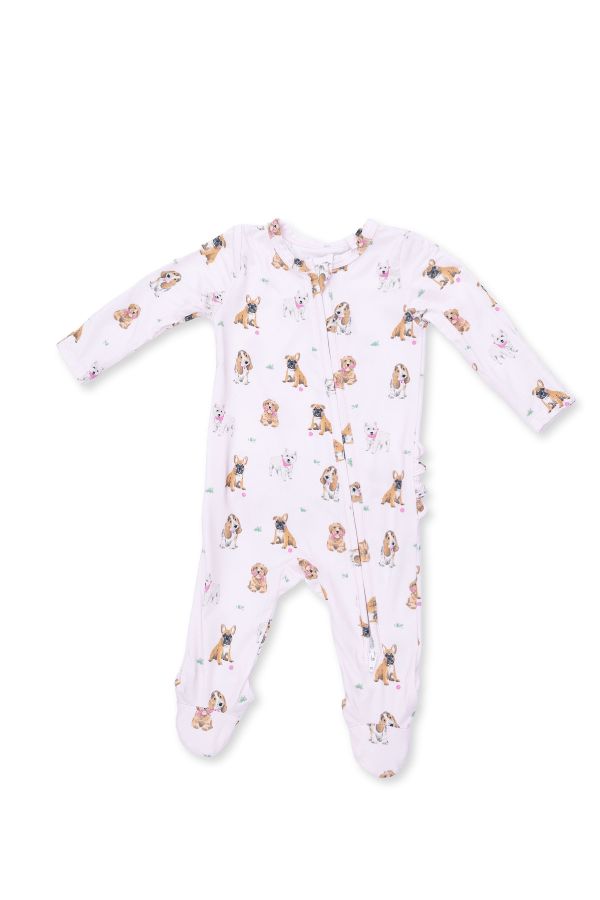 A baby long-sleeve footed sleeper in light pink with a repeating print of small brown and tan 'bestie dogs' , shown on a plain white background.