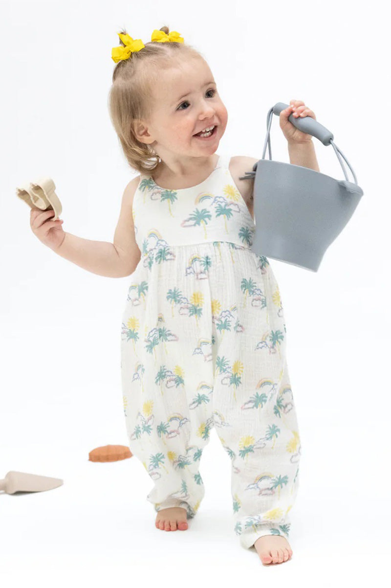 Tie-back romper in white with palm rainbow and sunshine pattern