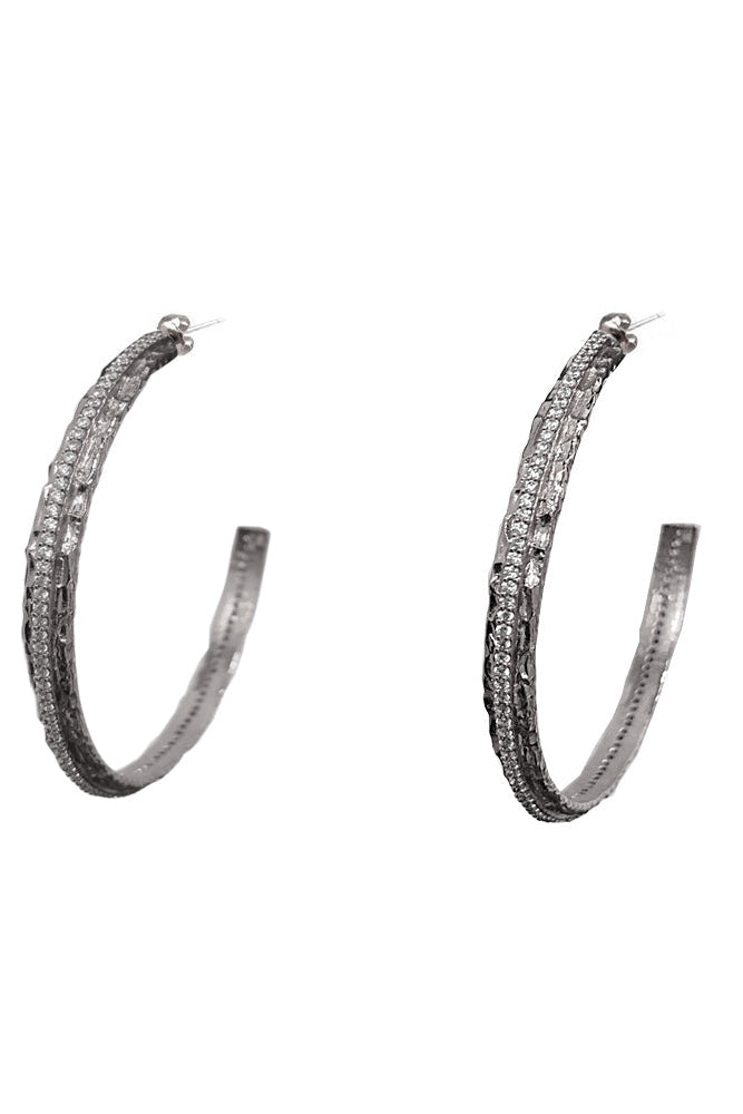 A pair of silver-tone crystal thin hoop earrings embellished with multiple rows of small clear stones, shown against a plain white background.