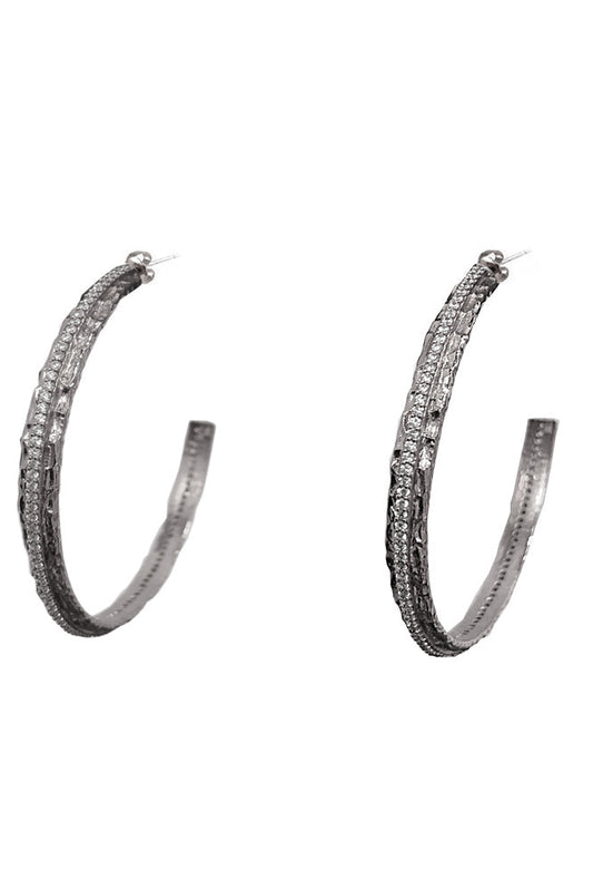 A pair of silver-tone crystal thin hoop earrings embellished with multiple rows of small clear stones, shown against a plain white background.