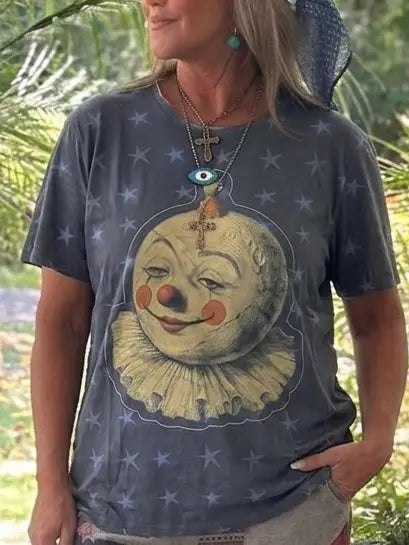 Navy graphic T-shirt with smiling clown face, eye motif, and scattered star prints