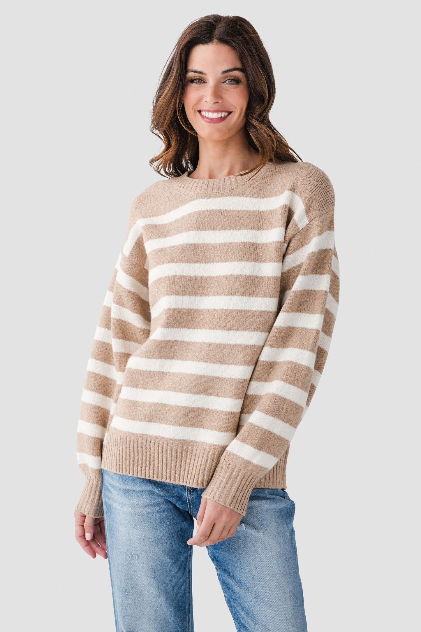 Striped tan-and-white knit sweater, crew neckline and long sleeves with ribbed cuffs