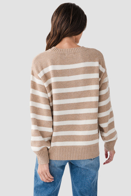 Back view of tan striped sweater with white horizontal stripes and ribbed cuffs and hem