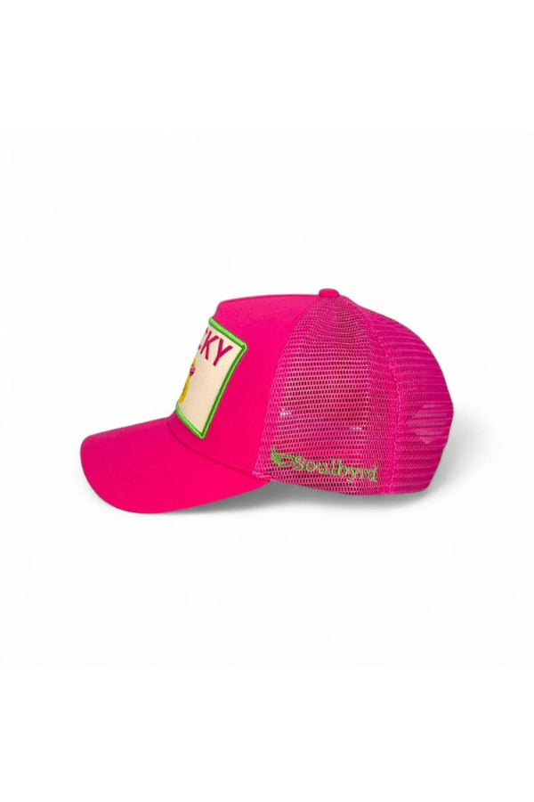 Pink trucker hat side view with mesh back and partial “LUCKY” patch