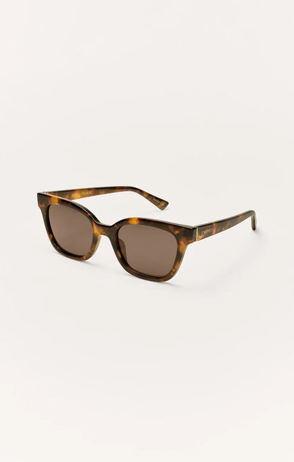 Brown tortoise polarized sunglasses shown from the side, dark brown lenses