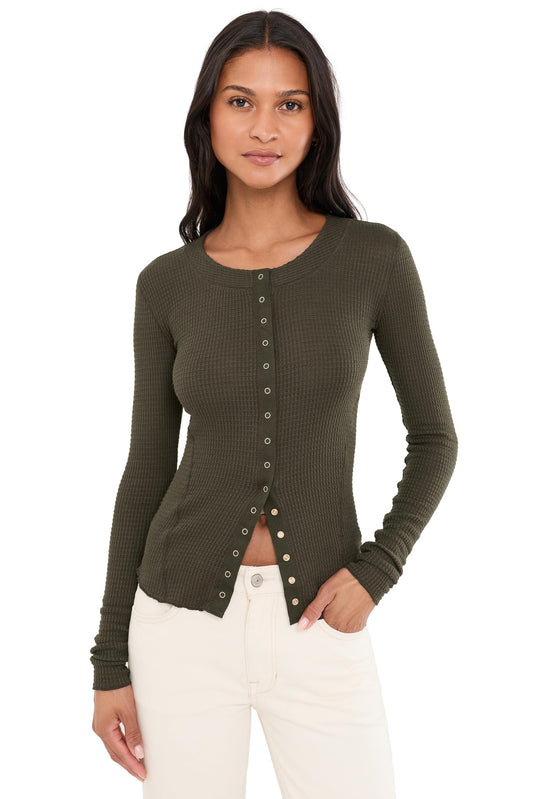 Woman wearing deep fudge going places cardi with white jeans 